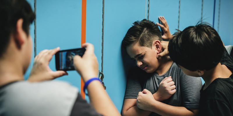 Kids, tweens online bullying in school, social media, it is illegal to cyberbully